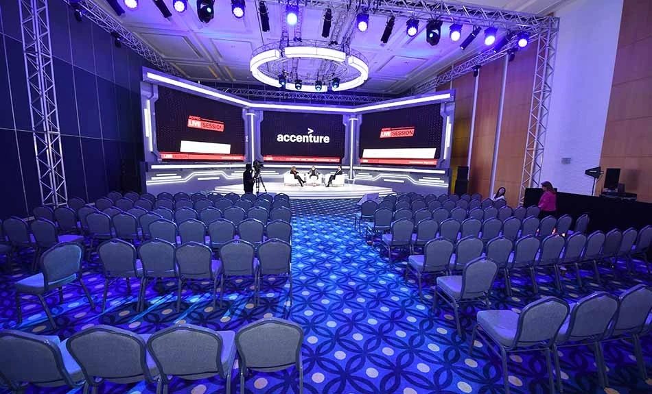 ADNEC Centre Abu Dhabi conference setup with stage and seating.