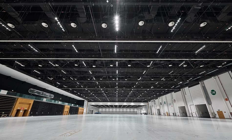 Spacious exhibition hall at ADNEC Centre, Abu Dhabi, with high ceilings.