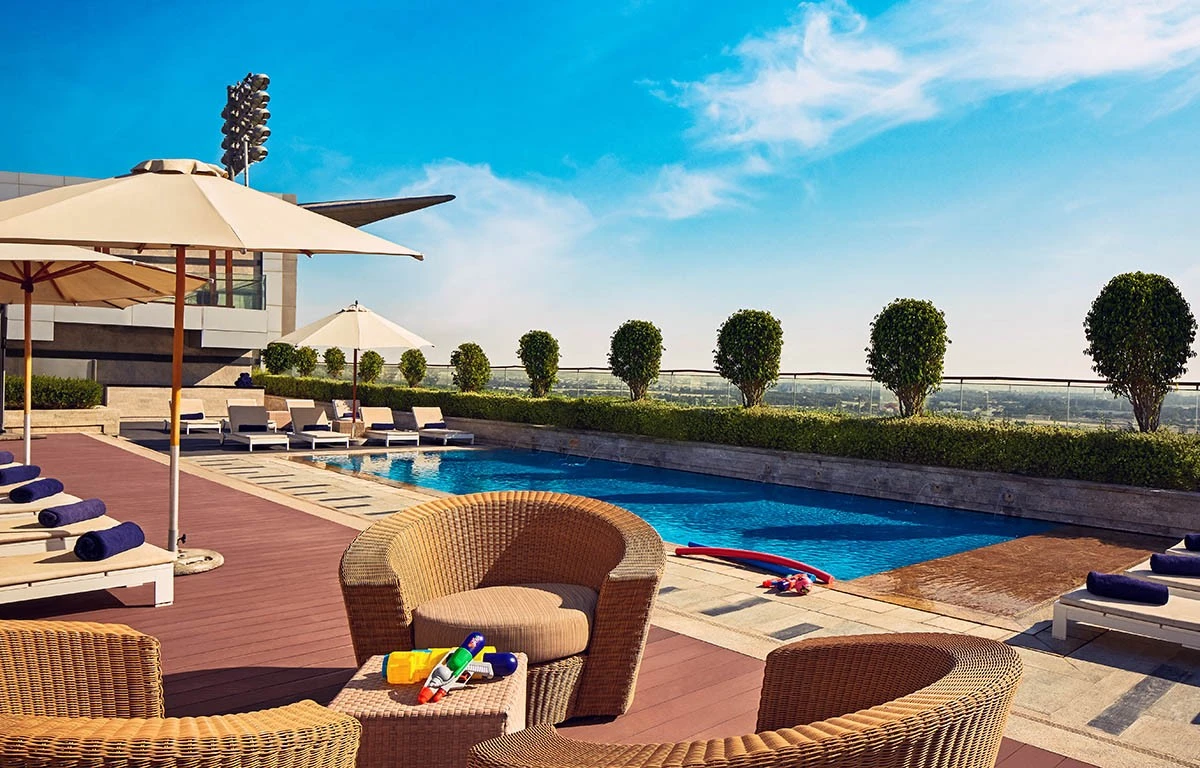 Kids pool area at The Meydan Hotel, Dubai with loungers.