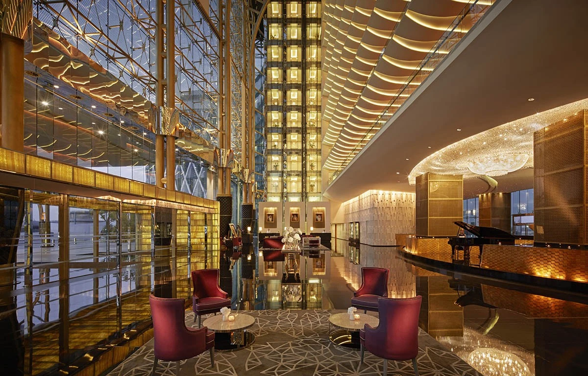 Luxurious lobby of The Meydan Hotel, Dubai with elegant seating.