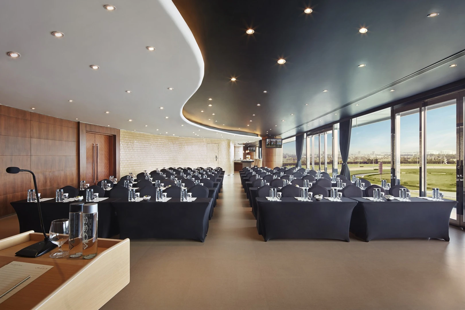 Conference room at The Meydan Hotel, Dubai, with elegant seating arrangement.