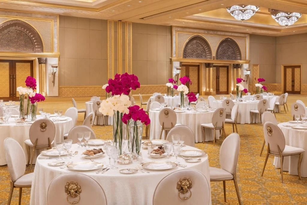 Opulent banquet hall with floral centerpieces, Emirates Palace, Abu Dhabi.