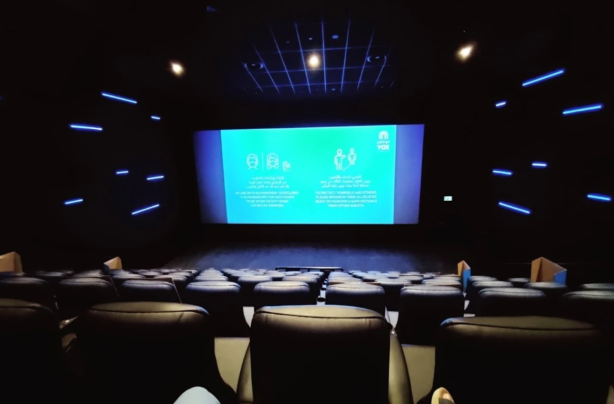 VOX Cinemas Al Jimi Mall auditorium with blue-lit screen, Al Ain.