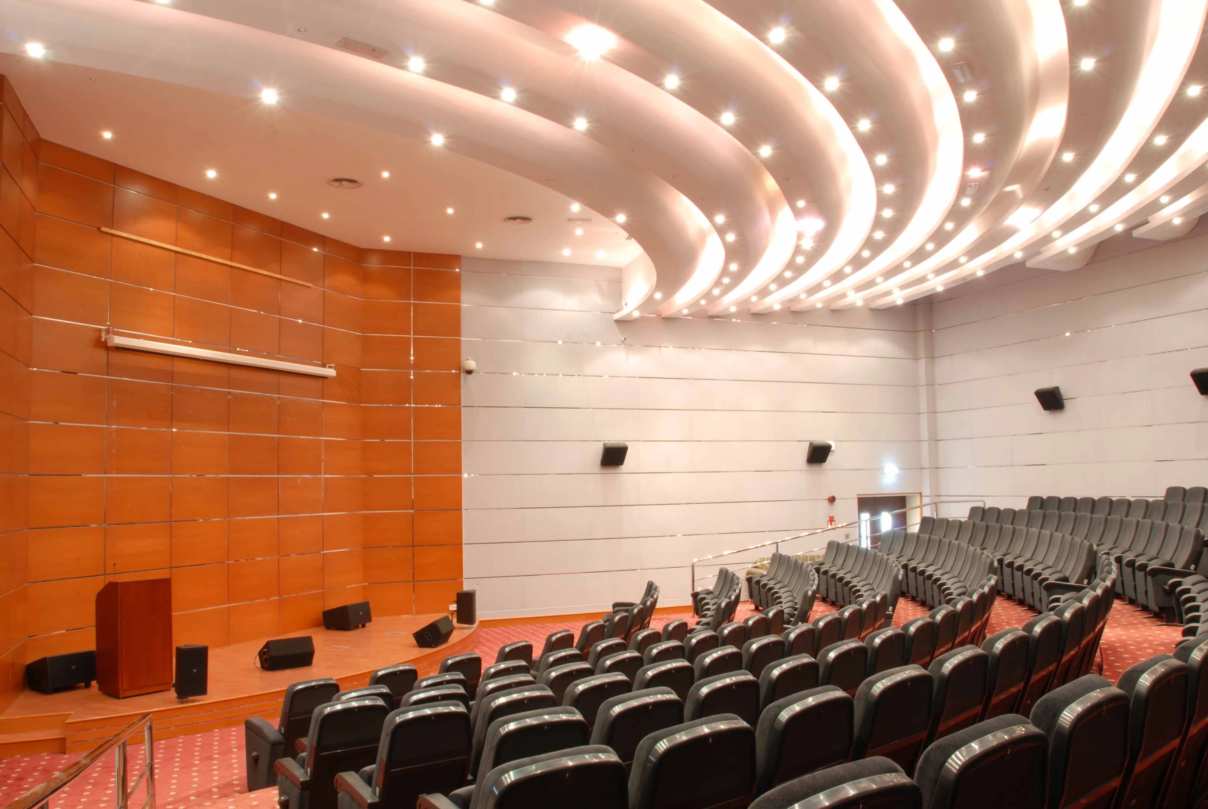 ADNEC Centre Al Ain auditorium with modern seating and lighting.