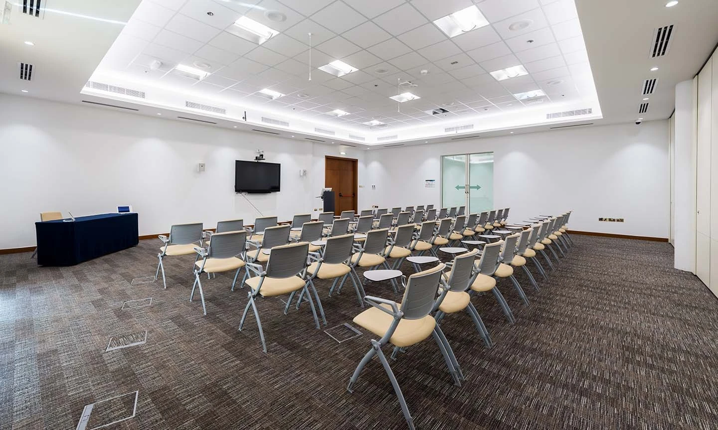 Modern conference room with rows of chairs at ADNEC Centre Al Ain.