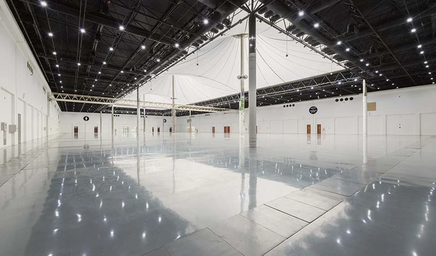Spacious hall at ADNEC Centre Al Ain with high ceilings and lights.