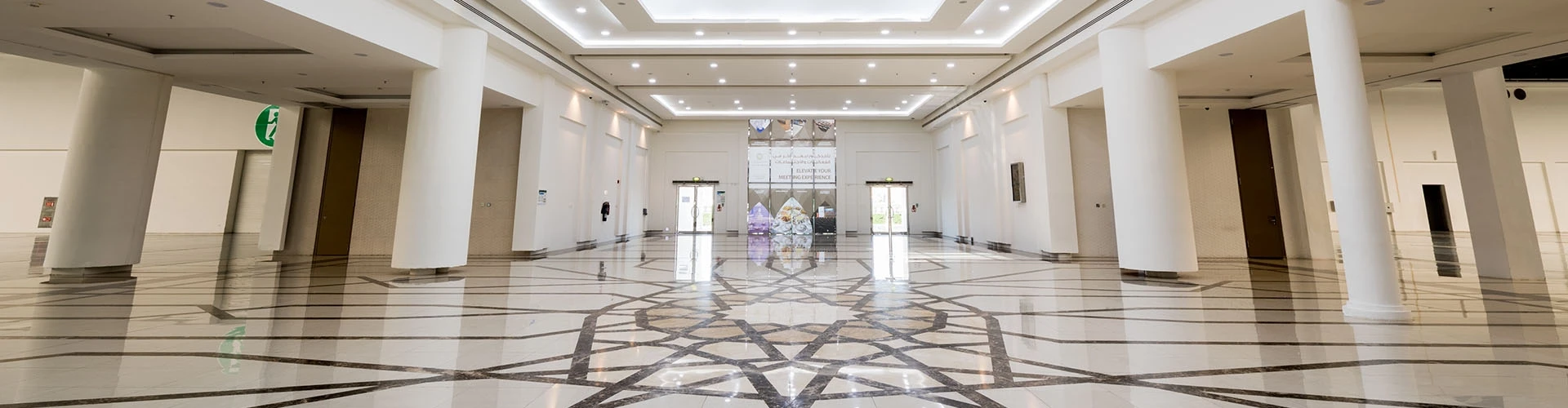 Spacious ADNEC Centre Al Ain lobby with geometric floor design.