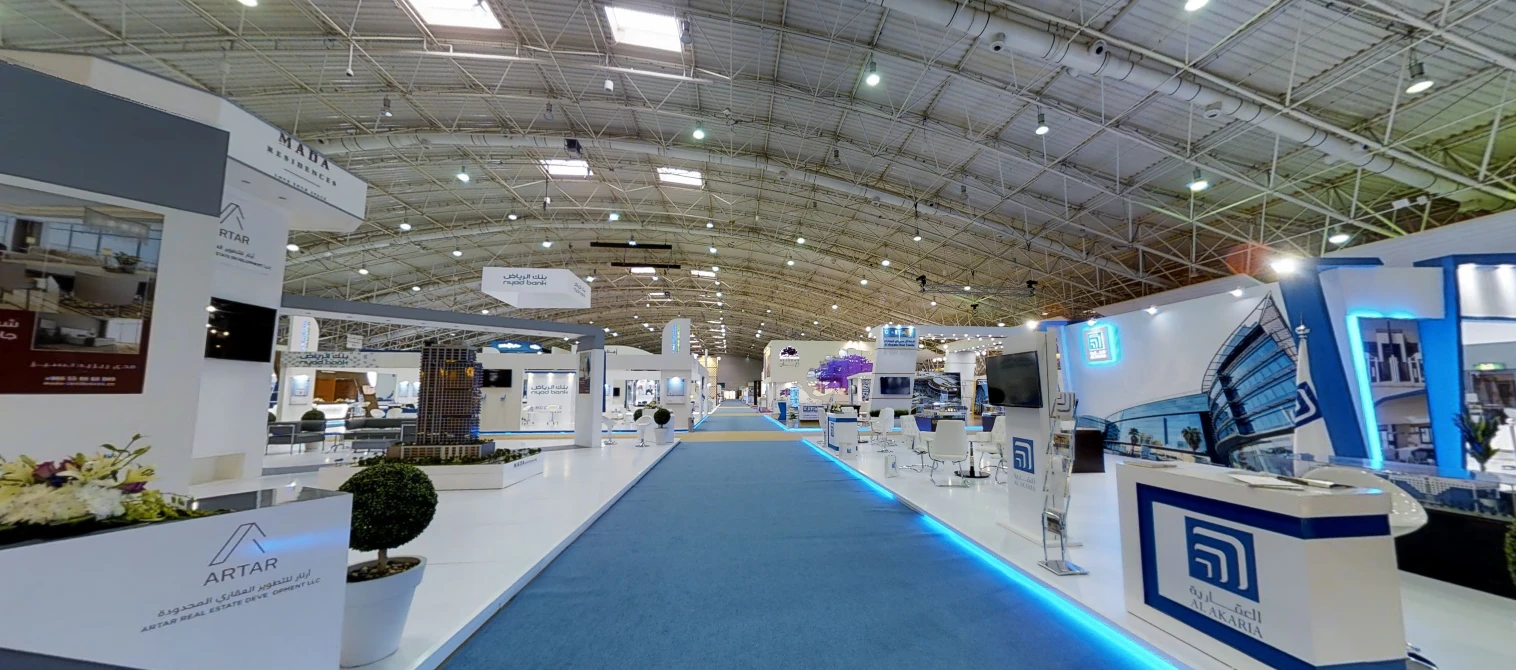Riyadh International Convention Center exhibition hall with various booths.