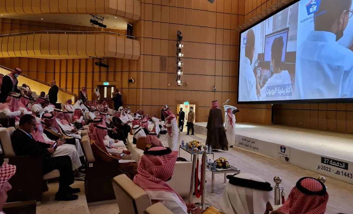 Conference at Riyadh International Convention Center, large audience and presentation screen.