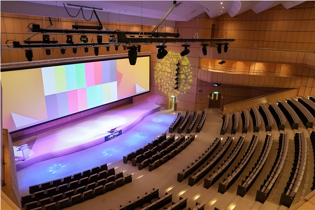 Riyadh International Convention Center auditorium with colorful stage lighting.
