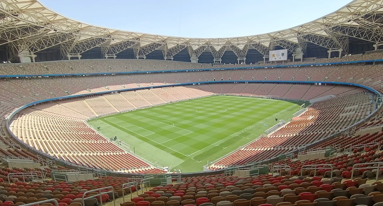 King Abdullah Sport City stadium in Jeddah, empty with green field.