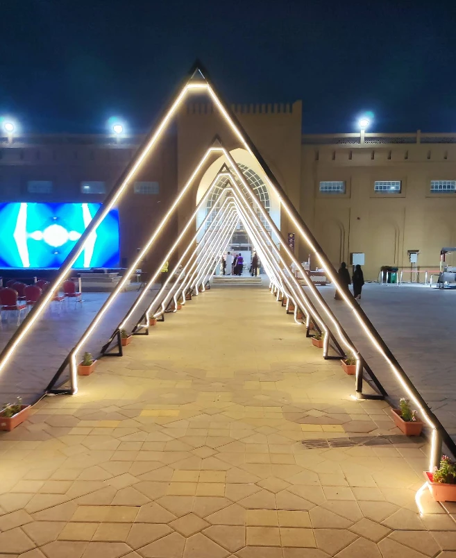 Illuminated entrance at Rak Expo Center, Ras Al-Khaimah, evening view.