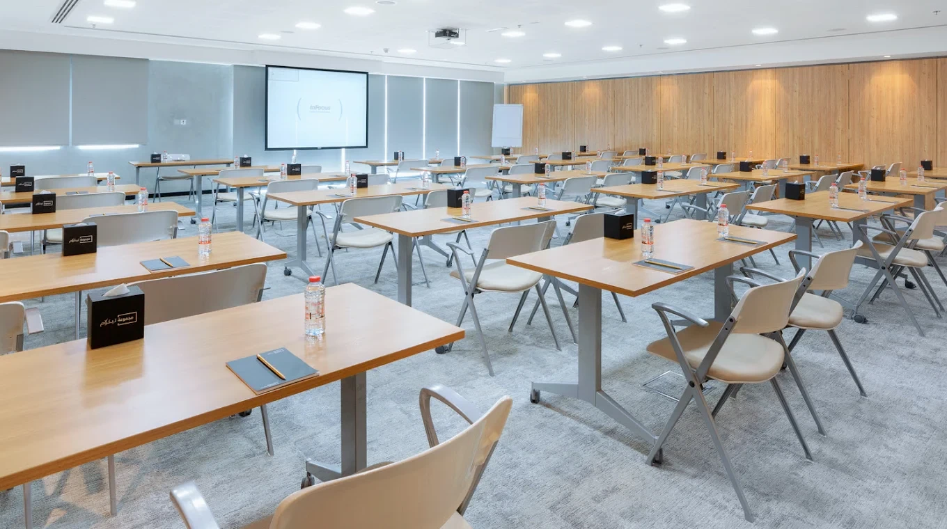 Conference Hall Dubai Knowledge Park, classroom setup with tables and chairs.