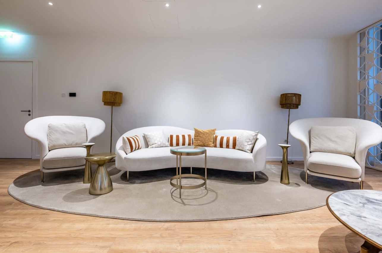 Modern lounge area at Expo City Dubai with white furniture.