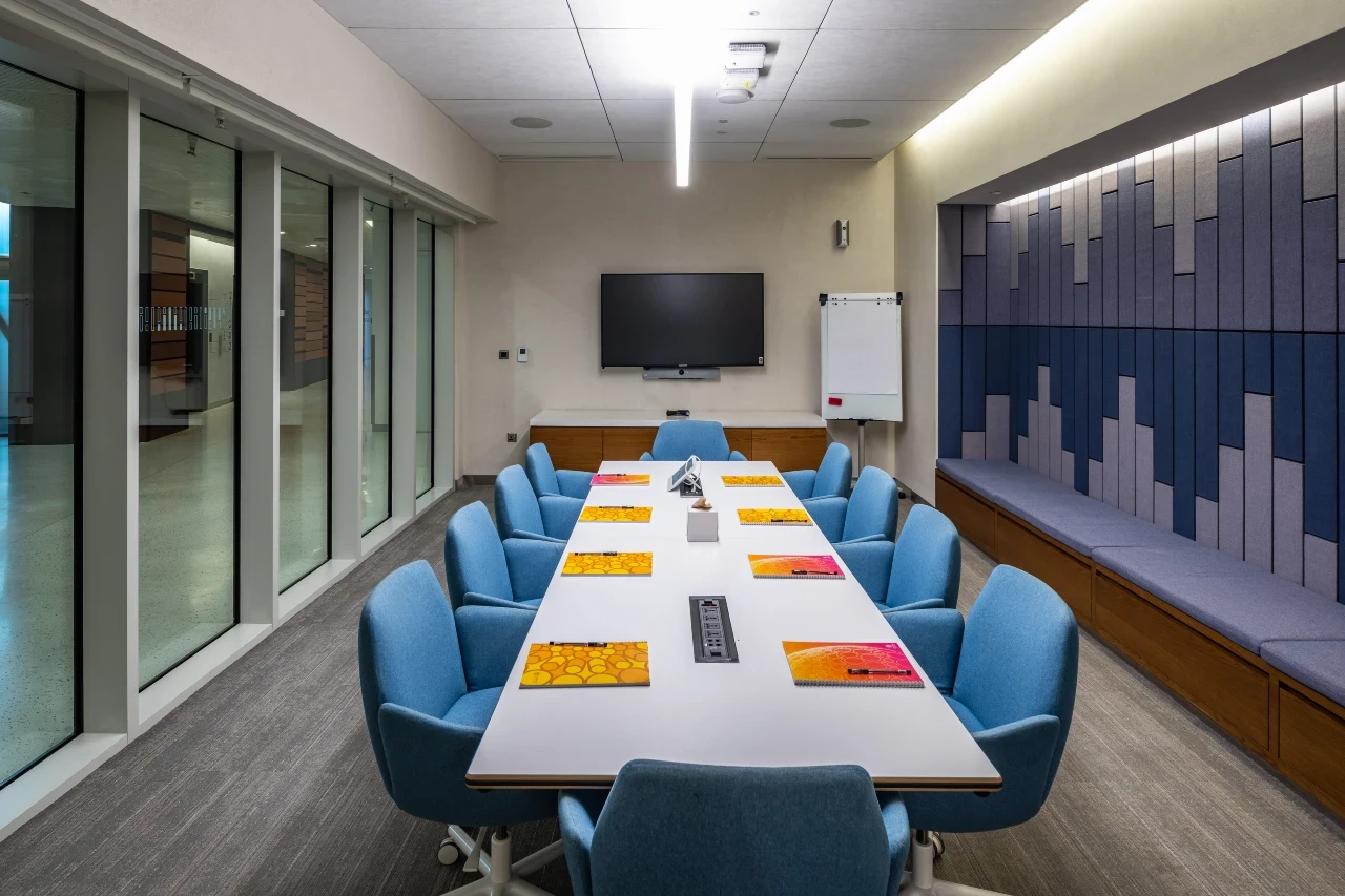 Conference room with blue seating and wall panels, Expo City Dubai.